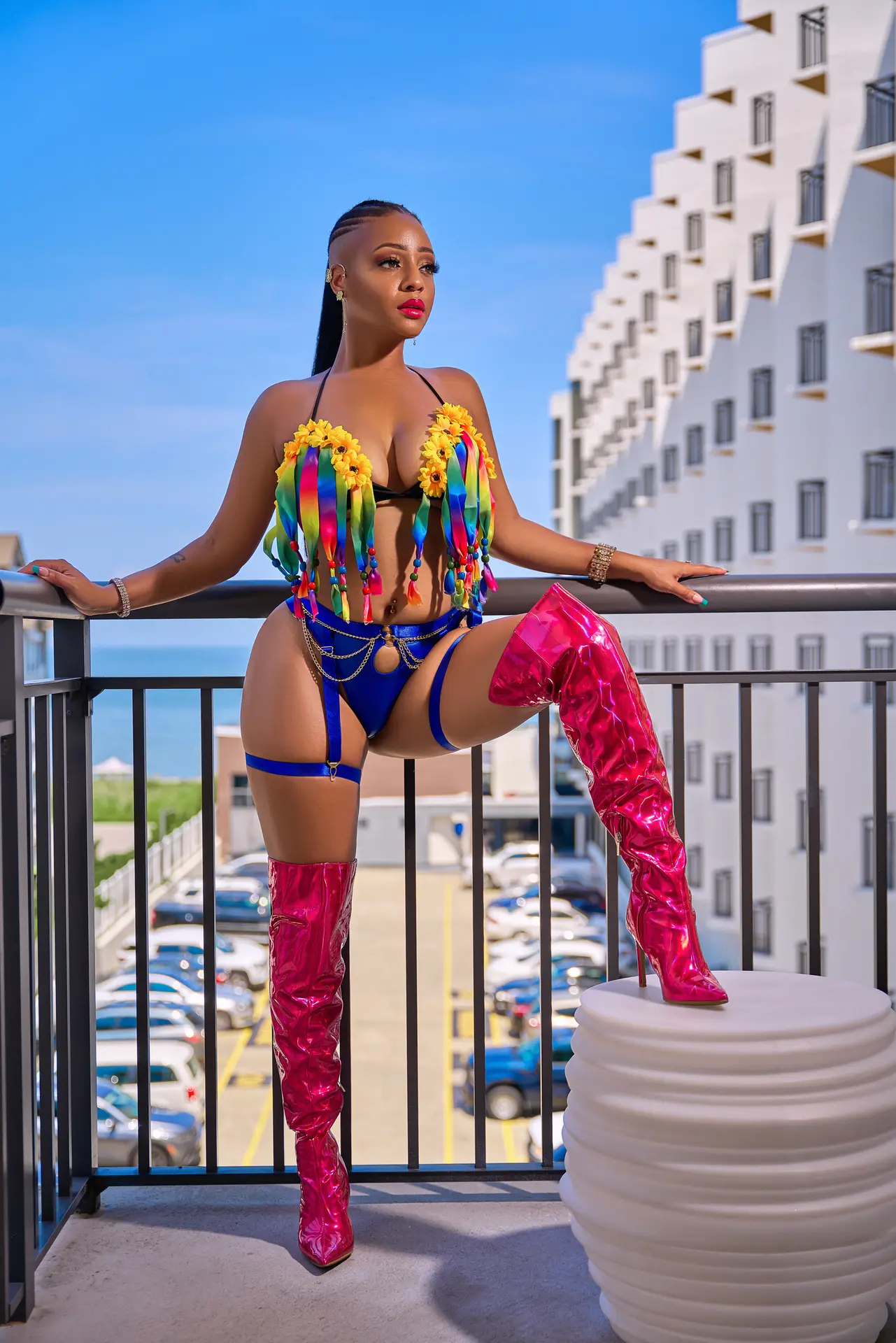 Jasmine Alysha standing in a vivid carnival-inspired fashion look